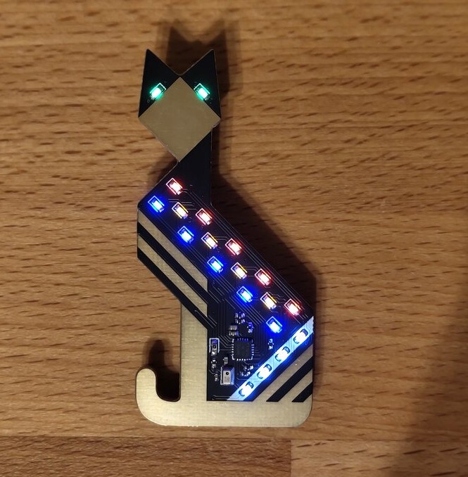 A black PCB with LEDS in the shape of a cat