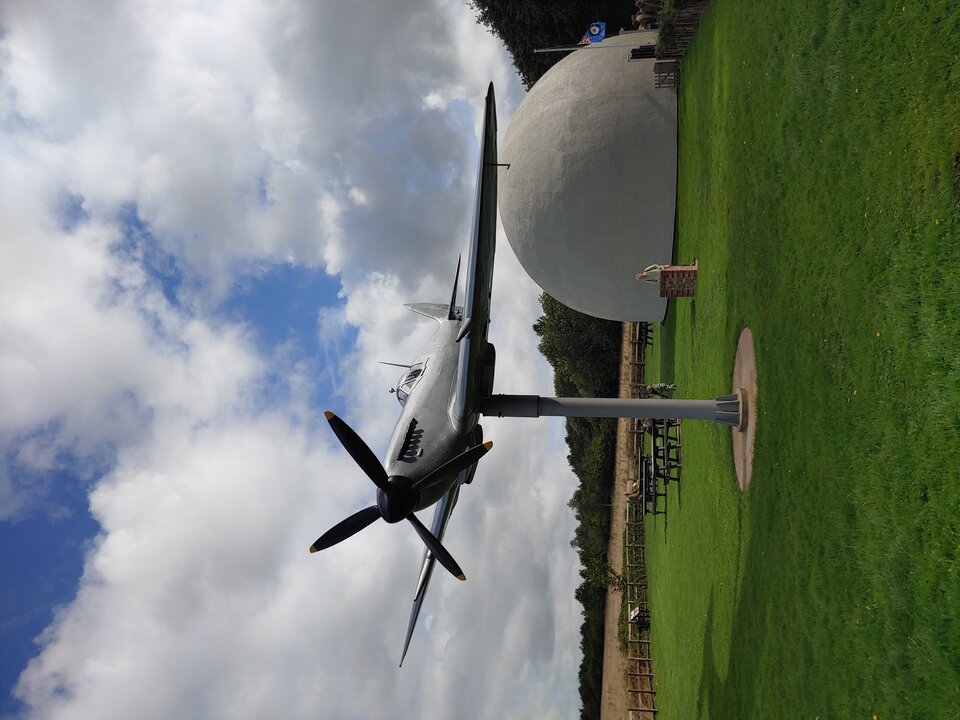 A view of the Langham Dome in the background with a pole mounted Spitfire in the foreground.